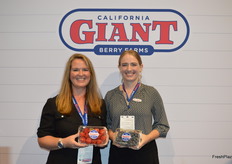 Kyla Oberman and Amelia Jackson with California Giant Berry Farms proudly show strawberries and blueberries.